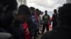 FILE - Migrants pray for Europe to grant them a place of safety as they travel aboard the Ocean Viking humanitarian ship in the Mediterranean Sea, Sept. 21, 2019. 