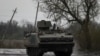 Ukrainian servicemen ride inside a M113 armoured personnel carried on a road to the front line town of Bakhmut in Donetsk region