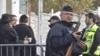 An armed police officer stands guard at the entrance of the Ozar Hatorah Jewish school in Toulouse, southwestern France, March 20, 2012.