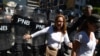 FILE - Supporters of the Venezuelan opposition confront members of the Bolivarian National Police as they attempted to block a main avenue during a protest against the government of President Nicolas Maduro, in Caracas, Venezuela, Nov. 18, 2019. 