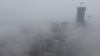 FILE -Buildings shrouded in heavy haze at Qingdao development zone, Shandong province, China.