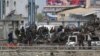Afghan security forces inspect the site of a Taliban-claimed deadly suicide attack in Kabul, Afghanistan, April 19, 2016. 