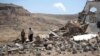 FILE - Forensic experts inspect the rubble of a house destroyed by a Saudi-led airstrikes on the outskirts of Sanaa, Yemen, Feb. 16, 2017.