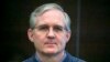 FILE - Paul Whelan, a former U.S. Marine who was arrested for alleged spying, listens to the verdict in a courtroom at the Moscow City Court in Moscow, Russia, June 15, 2020.