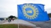 FILE - A United Auto Workers flag flies near strikers outside the General Motors Orion Assembly plant in Orion Township, Mich., Sept. 30, 2019.