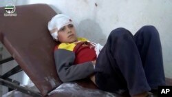 This photo provided by Muaz al-Shami, Syrian Revolution Network, an opposition activist media organization, shows a bandaged child on a hospital bed after airstrikes killed nearly 30 people, mostly children, in the northern rebel-held village of Hass, Syria, Oct 26, 2016.