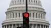 A stoplight is seen in front of the dome of the US Capitol as a government shut down looms in Washington, DC, on September 28, 2023.