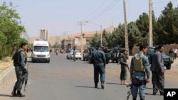FILE - Afghan police soldiers inspect the site of a bomb attack, in Herat, Afghanistan, Saturday, July 30, 2016. 