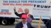Bob Bolus, a supporter of U.S. Republican presidential candidate Donald Trump, gives the thumbs up to drivers as they pass by on Super Tuesday in Middleburg Heights, Ohio, March 15, 2016. 