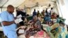 FILE - A nurse attends to mothers whose children are suffering malnutrition in a clinic set up by health authorities in collaboration with Medecins Sans Frontieres or Doctors Without Borders in Katsina State, northwest Nigeria, on July 20, 2022.