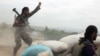 FILE - An Afghan National Army soldier, left, shouts against the Taliban, after firing a rocket towards Taliban positions, on the outskirts of Kunduz, northern Afghanistan, April 16, 2016.