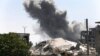 FILE - Black smoke rises from a coalition airstrike which attacked an Islamic State militant position, on the front line on the eastern side of Raqqa, Syria, July 26, 2017.