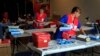 New Hampshire state Laboratory Scientist set up a make shift lab at the middle school, Saturday, Aug. 11, 2012 in Stratham, N.H. The state Health Department set up the clinic to test hundreds of people for hepatitis C related to an outbreak at Exeter Ho