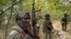 FILE - In this photo from video released by the Russian Defense Ministry on Sept. 23, 2024, Russian soldiers patrol a trail in the Russian-Ukrainian border area in Russia's Kursk region. (Russian Defense Ministry Press Service via AP)