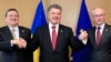 Ukraine's President Petro Poroshenko poses with European Commission President Jose Manuel Barroso (L) and European Council President Herman Van Rompuy (R) at the EU Council in Brussels, June 27, 2014.