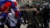 FILE: Protesters clash with police as they attempt to go toward the Phnom Penh Municipal Court, in central Phnom Penh April 25, 2014. 