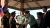 FILE - Cambodian Defense Minister Tea Banh, second left, shakes hands with a Chinese army adviser during a graduation ceremony at the Army Institute in Kampong Speu province, March 12, 2015. 