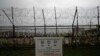 A directional sign showing the distance to N. Korea's Kaesong city and S. Korea's capital Seoul is seen near the wire fences decorated with ribbons written with reunification wishing at the Imjingak Pavilion in Paju, S. Korea, May 26, 2020.