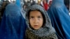 Afghan refugees wait for their documents to go back to Afghanistan at the UNHCR's Repatriation Center in Peshawar, Pakistan on June 23, 2016. 