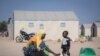 FILE - A displaced Burkinabe woman and child prepare food, in the Pissila town camp, near Kaya, Burkina Faso, Dec. 10, 2019. 