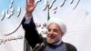 Iran's President Hassan Rouhani waves to participants while he attends a ceremony to mark the beginning of the universities academic year, at the Tehran University, in Tehran, Iran, Oct. 14, 2013. 