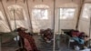 FILE - Patients suffering from cholera receive treatment inside a tent converted into a temporary field hospital near the remote village of Dor, Sudan, April 28, 2017.