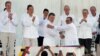 Colombia’s President Juan Manuel Santos, front left, and the top commander of the Revolutionary Armed Forces of Colombia (FARC) Rodrigo Londono, known by the alias Timochenko, shake hands after signing the peace agreement between Colombia’s government and