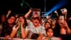 Spectators chant "Justice" in Spanish during a concert by female performers on the eve of International Women's Day, in the Zocalo in Mexico City, March 7, 2020.