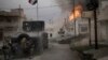 FILE - A car bomb explodes next to Iraqi special forces armored vehicles as they advance toward Islamic State held territory in Mosul, Iraq, Nov. 16, 2016. 