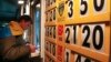 FILE - A man exchanges money at a currency exchange office in Kyiv, April 2014.