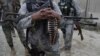FILE - Afghan security forces guard a checkpoint in Spein Boldak at the border with Pakistan, Kandahar province, Afghanistan, Jan. 25, 2016. U.S. and NATO allies have conducted nearly 100 counterterrorism strikes in Afghanistan this year that mostly targeted Islamic State fighters, they said.