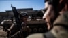 An Iraqi soldier from the 9th Infantry Division carries a machine gun while heading to the front line in Mosul, Iraq, Dec. 6, 2016. On Wednesday, Iraqi forces ask for U.S. air support after taking fire from Islamic State fighters inside a hospital complex.