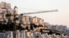 FILE - A crane is seen next to homes in the Har Homa Jewish settlement in Jerusalem.