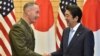 General Joseph Dunford, left, the chairman of the U.S. Joint Chiefs of Staff, shakes hands with Japan's Prime Minister Shinzo Abe at Abe's official residence in Tokyo, Japan, Aug. 18, 2017.