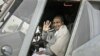 Indian Defense Minister A.K. Antony waves while sitting in the cockpit of an Indian Air Force Mi-17 V5 helicopter during its induction ceremony in New Delhi, India, Feb. 17, 2012.