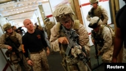 FILE - U.S. Marines work with instructors on a building-clearing drill in Chesapeake, Virginia, Sept. 25, 2012.