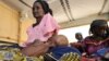 FILE - Mothers and their malnourished children at an intensive nutritional rehabilitation center in Tanout, southern Niger, April 27, 2010.