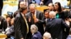 Dutch U.N. Ambassador Karel van Oosterom, center, speaks to Italian Foreign Minister Paolo Gentiloni, seated, center, while Dutch Foreign Minister Bert Koenders, left, and Italian U.N. Ambassador Sebastiano Cardi, right, listen during the U.N. Security Council elections in New York, June 28, 2016.
