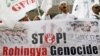  A Muslim Indonesian holds a banner during a protest in front of the Burma Embassy in Jakarta, Indonesia, July 13, 2012. 