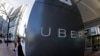 FILE- A woman leaves Uber headquarters of Uber in San Francisco, California.