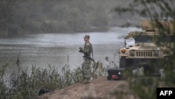 A US National Guard soldier guards the border with Mexico at Eagle Pass, Texas, on December 23, 2023.