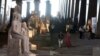 Visitors walk past ancient Egyptian colossal statues along the Grand Staircase at the Grand Egyptian Museum in Giza, Egypt, October 15, 2024.