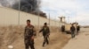Smoke rises from a building, where Taliban insurgents hide during a firefight with Afghan security forces, in Helmand province, southwest Afghanistan, March 9, 2016.