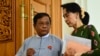 FILE - Zaw Myint Maung, left, an imprisoned politician and a close colleague of Myanmar’s ousted leader Aung San Suu Kyi, right, talks with Suu Kyi at Parliament in Naypyitaw, July 23, 2015.