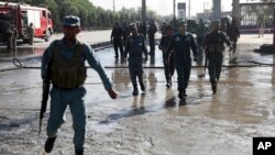 Afghan police soldiers inspect the site of a suicide attack in Kabul, Afghanistan, Monday, June 20, 2016.