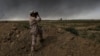 An Iraqi army member looks toward Islamic State group territory outside Qayyarah, Oct. 4, 2016. Qayyarah has become an important staging ground for military and humanitarian efforts ahead of the Mosul operation. 