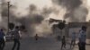 Smoke rises over the streets after an mortar bomb landed from Syria in the border village of Akcakale, southeastern Sanliurfa province, October 3, 2012.
