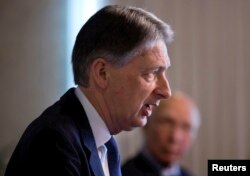 British Foreign Secretary Phillip Hammond, left speaks during a joint news conference with Pakistan Foreign Affairs Adviser Sartaj Aziz at the Foreign Ministry in Islamabad, Pakistan, Tuesday, March 8, 2016.