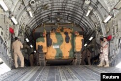 Turkish troops seen unloading a vehicle at their military base in Doha, Qatar, June 23, 2017.