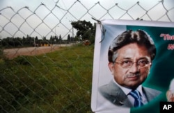 FILE - A poster of former Pakistani President Pervez Musharraf is seen hung up near a checkpoint outside his house, where he had been held under house arrest in Islamabad, Pakistan on Nov. 6, 2013.